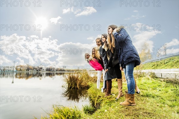 Women overlooking still river