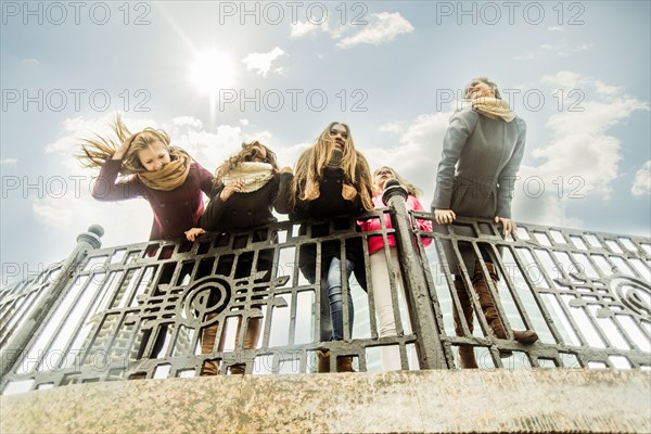 Women leaning over banister