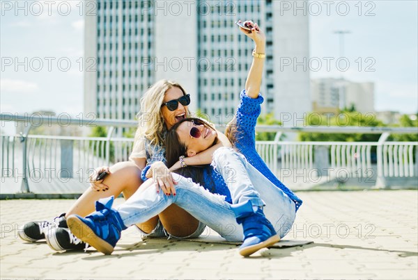 Women taking picture on city street