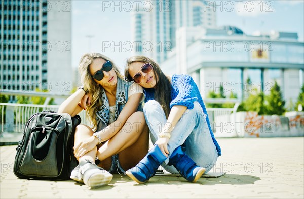 Women sitting on city street