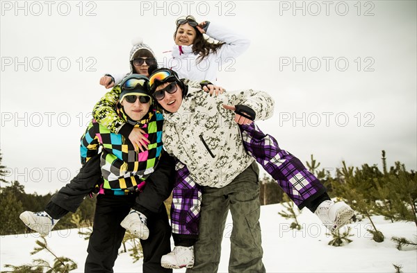 Caucasian friends playing together in snow