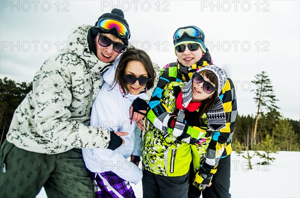 Caucasian friends smiling in snow