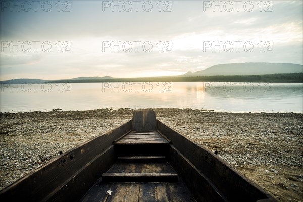 Dilapidated boat at rural lake