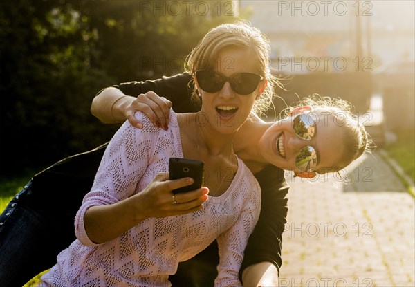 Caucasian women taking cell phone selfie