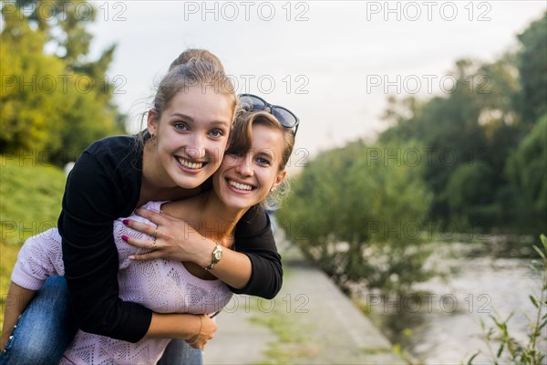 Caucasian women playing near river