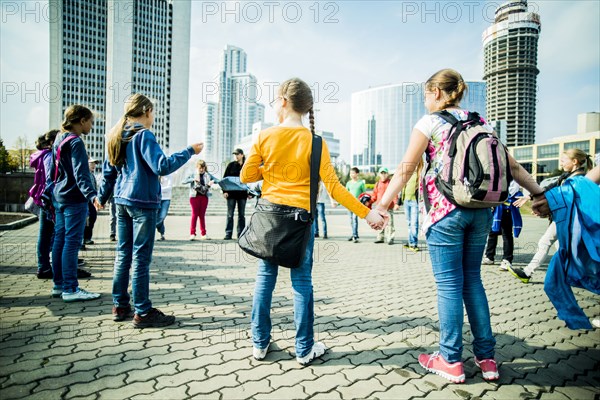 Caucasian children playing in city square