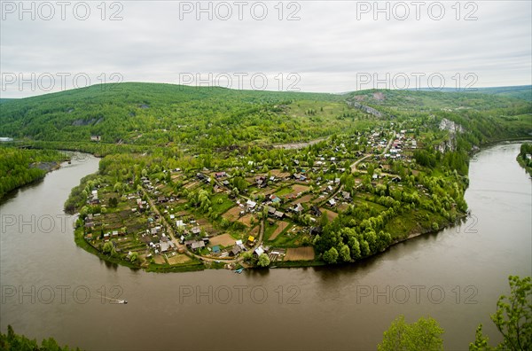 Aerial view of village near bend in river