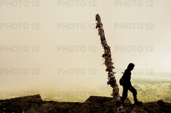 Caucasian hiker walking on rocky hilltop