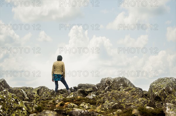 Caucasian hiker standing on rocky hilltop