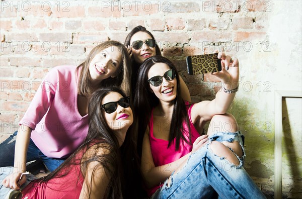 Caucasian women taking cell phone selfie