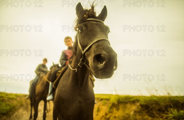 Close up of Caucasian child riding horse