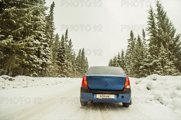 Car driving on snowy remote road