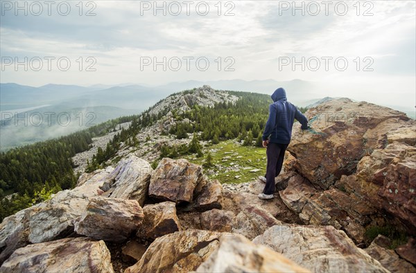 Caucasian hiker standing on rocky hilltop