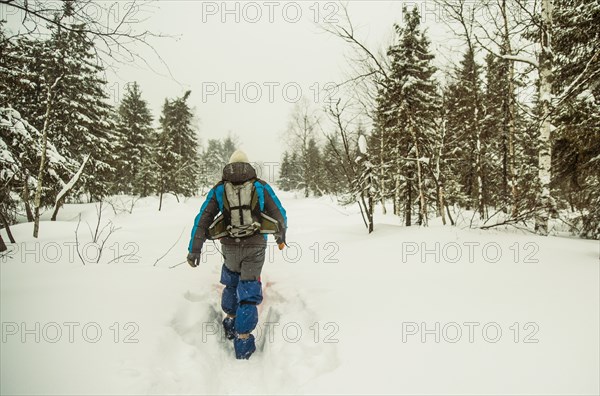 Caucasian hiker walking in deep snow