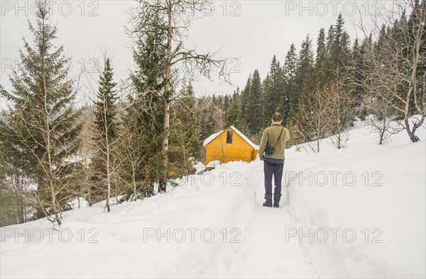 Caucasian man standing on snowy hillside