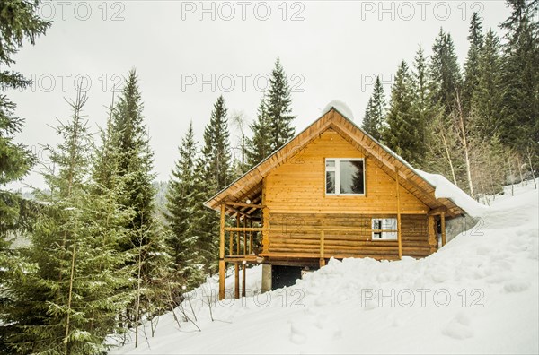 Cabin on snowy remote hillside