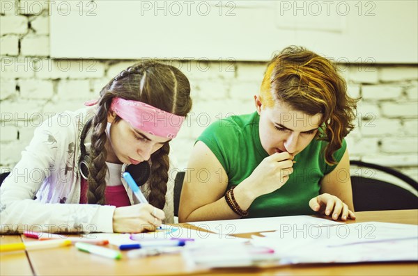 Caucasian women drawing in art class