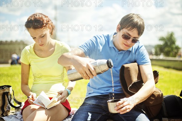 Caucasian couple relaxing in park