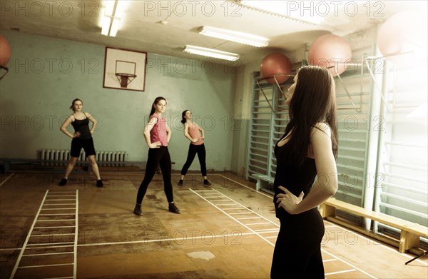 Caucasian dancers rehearsing in gym