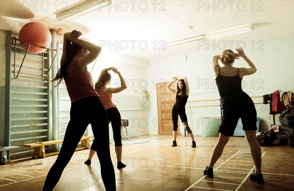 Caucasian dancers rehearsing in gym