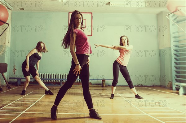 Caucasian dancers rehearsing in gym