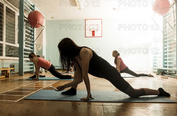 Caucasian dancers stretching in gym