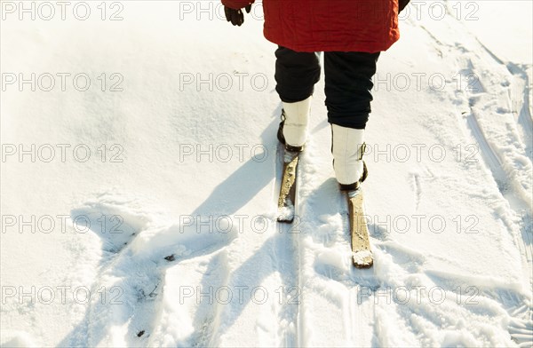 Caucasian woman cross-country skiing in snowy field