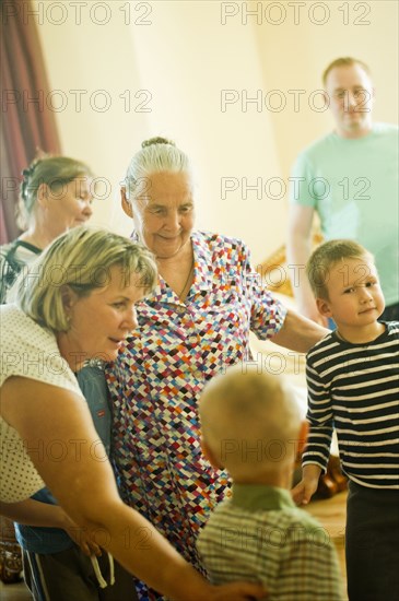 Caucasian multi-generation family relaxing indoors