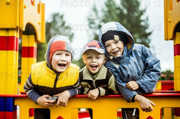 Caucasian boys smiling at playground