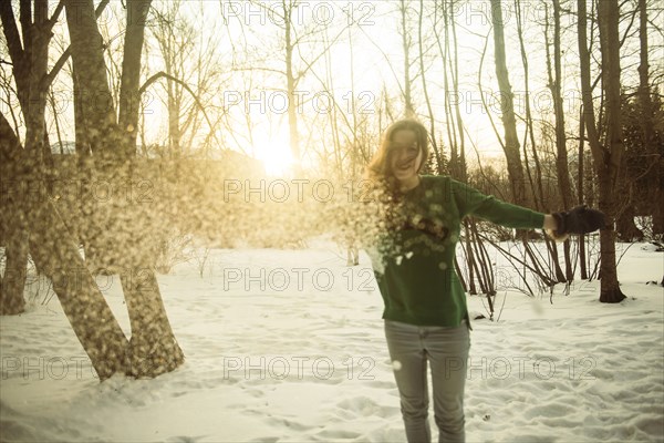 Caucasian woman playing in snowy field