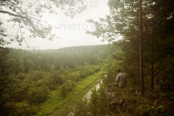 Caucasian man admiring scenic view from rural hilltop