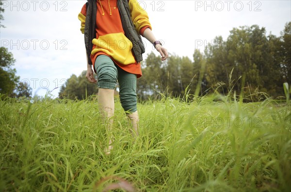 Close up of barefoot Caucasian woman walking in park