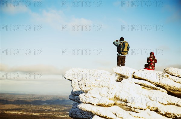 Caucasian hikers admiring scenic view from mountaintop