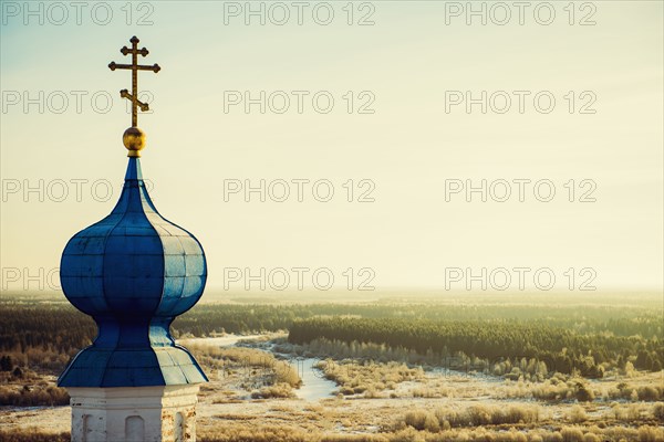 Ornate church spire over rural landscape