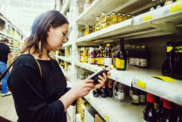 Caucasian woman shopping in grocery store