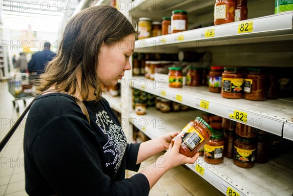 Caucasian woman shopping in grocery store