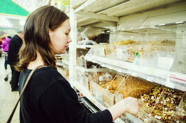 Caucasian woman shopping in grocery store
