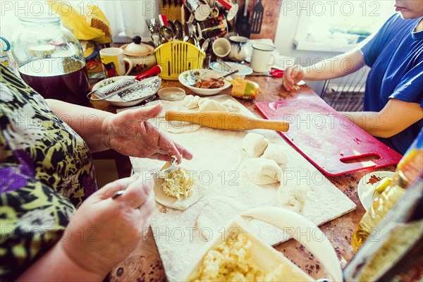 Caucasian mother and daughter cooking in kitchen