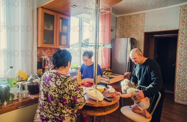 Caucasian family cooking in kitchen