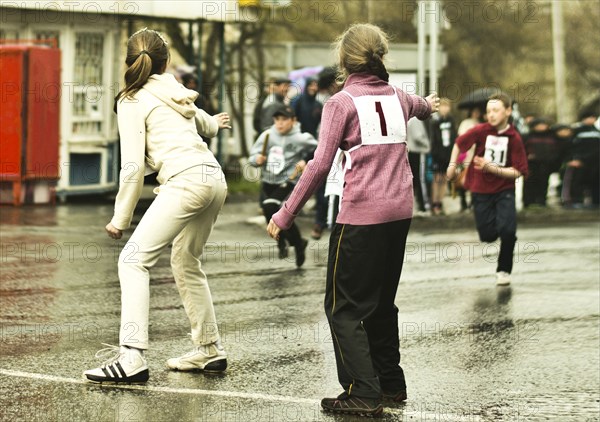 Caucasian children preparing for race on street