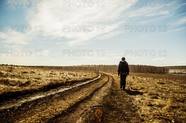 Caucasian woman walking in rural field