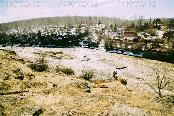 Caucasian men standing near remote river