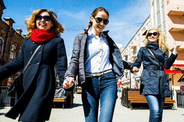 Caucasian women walking in city