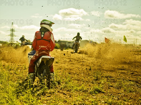 Caucasian motocross biker waiting on race course