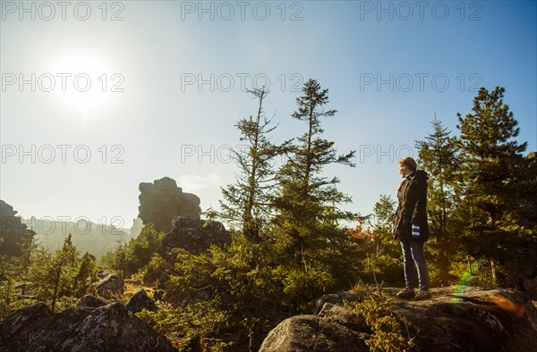 Caucasian hiker admiring view from remote hilltop