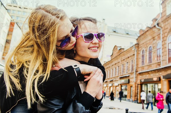 Women hugging in city