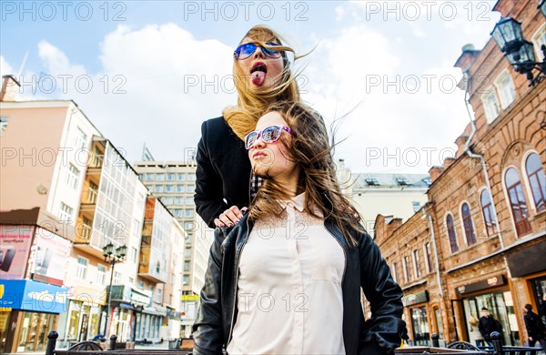 Low angle view of women playing in city
