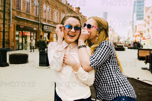 Women making faces in city