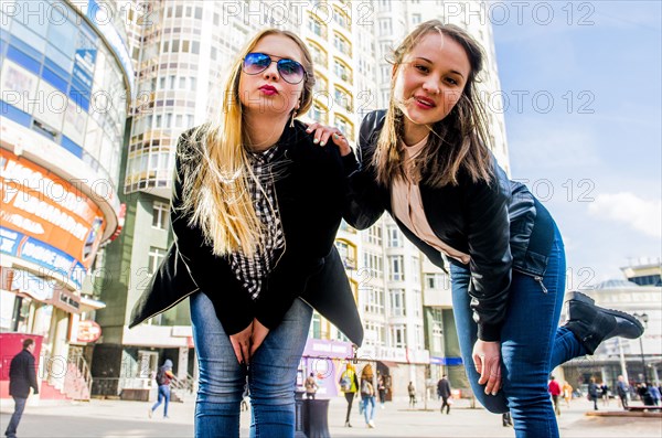 Low angle view of women leaning in city