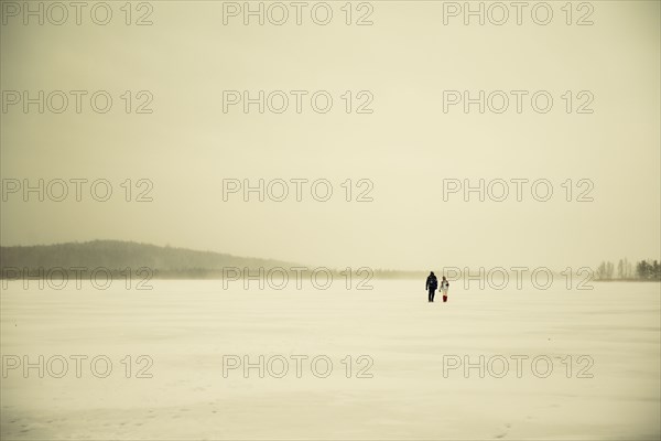 Caucasian hikers walking in snowy remote field